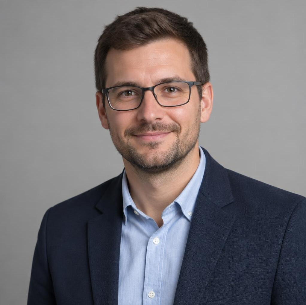 Studio portrait of a Croatian man with short hair and glasses