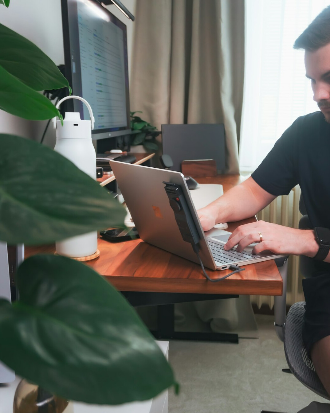 programmer working on laptop at desk