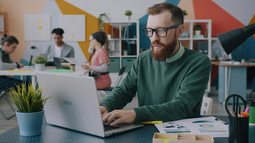programmer working on laptop at desk