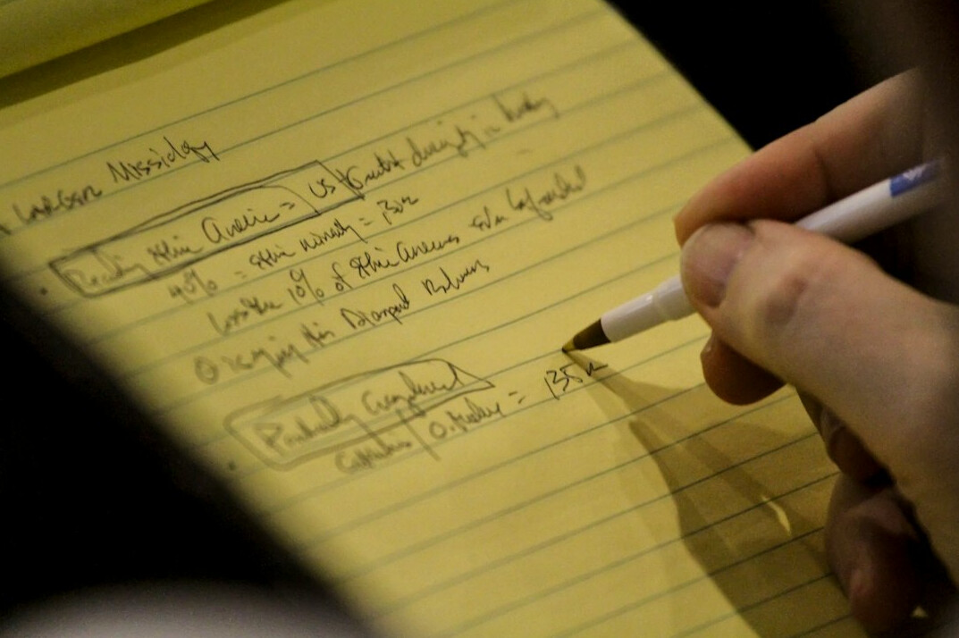 person writing to do list on paper