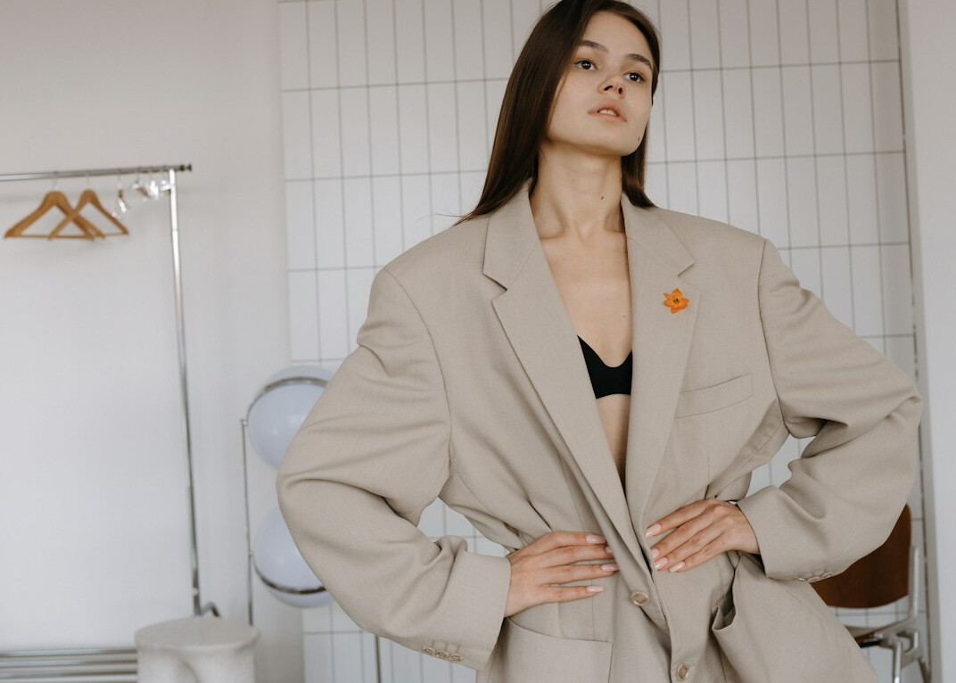 Studio portrait of a young Croatian woman with long brown hair in a blazer